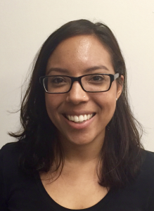 This is a headshot of Laurel Stokes. She is smiling and wearing glasses.