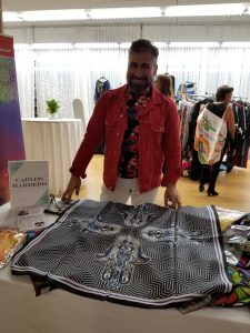 Artist displays his handmade scarf.