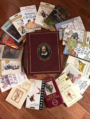 Photo of a leather-bound edition of Shakespeare's Complete Works surrounded by individual copies of Shakespeare's plays.