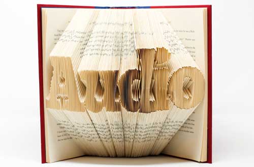 The word audio is folded into the paper edges of a book.