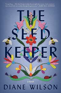 The book cover for the Seed Keeper, a 2021 Great Group Reads selection, is bluish-purple. Throughout the title, embroidered flowers and bees are woven.