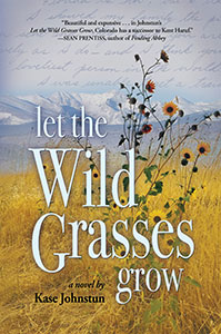 The book cover for Let the Wild Grasses Grow shows a pastoral scene with yellow grasses with one wild flower weed growing and mountains in the distance. Where the sky would be is faint cursive writing like in a letter.